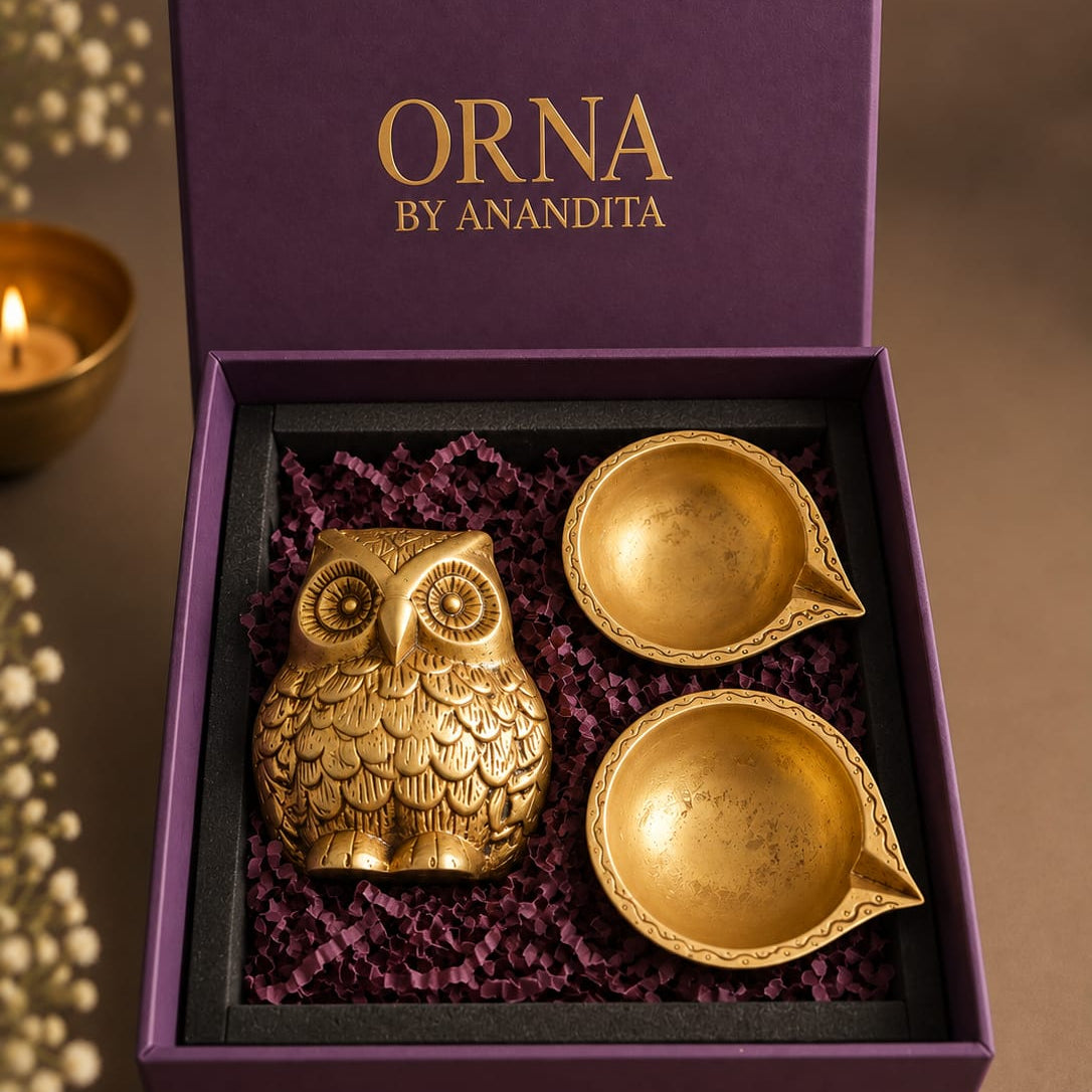 ORNA Diwali hamper with a miniature pure brass owl and two brass diyas in a purple gift box